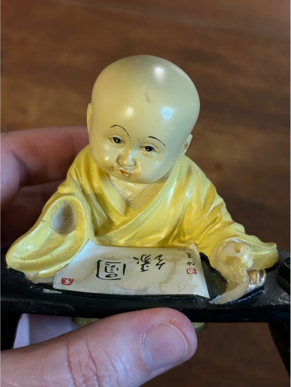 Vintage Yellow Monk Figurine with Scroll and Black Stand